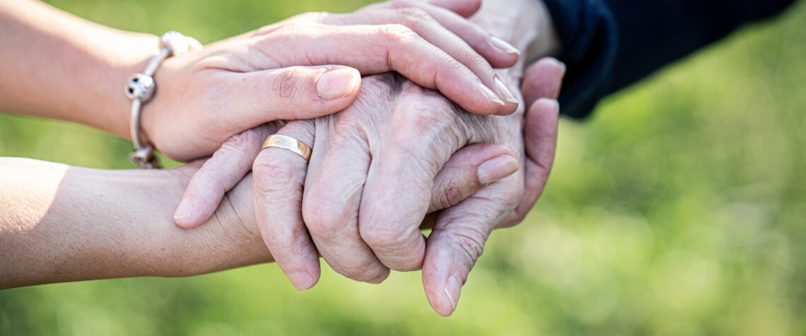 Caregiver holding elder hand in hospice care | Nashville Christian Family Magazine