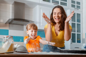 How to Love Your Child Through Words of Affirmation - Mother and daughter having fun & laughing in the kitchen | April 2022 Issue - Free Christian Lifestyle Magazine | Nashville Christian Family Magazine