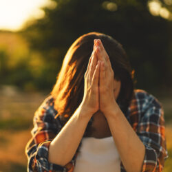 Young woman praying outside | Nashville Christian Family Magazine