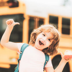 Young student in front of a school bus | Nashville Christian Family Magazine - Free Christian Magazine