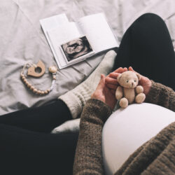 Unplanned Grandparenting - Pregnant woman holding small teddy bear | Nashville Christian Family Magazine - Free Christian Magazine