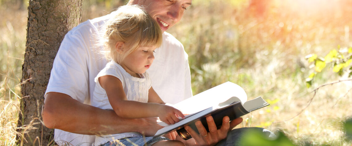 Resilient Child Discipleship -Happy Parents with a child read the Bible | Nashville Christian Family Magazine - Free Christian Magazine