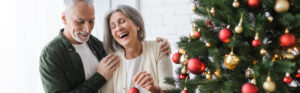 Elderly couple hanging Christmas Tree ornaments | Nashville Christian Family Magazine - Free Christian Magazine