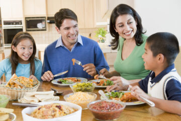 Resolve in 2023 To Eat Together as a Family Dinner - Family enjoying a meal together | Nashville Christian Family Magazine - Free Christian Magazine