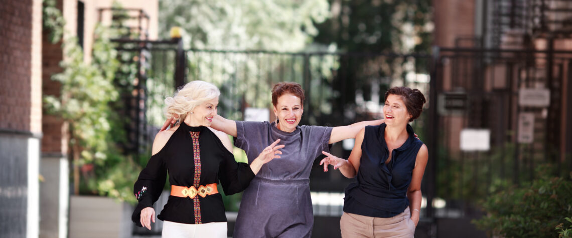 3 women smiling as they are walking through an urben setting | April 2023 issue \ Nashville Christian Family Magazine