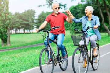 Information Overload over your health | Portrait of 2 happy & smiling seniors riding bicycles | April 2023 issue \ Nashville Christian Family Magazine
