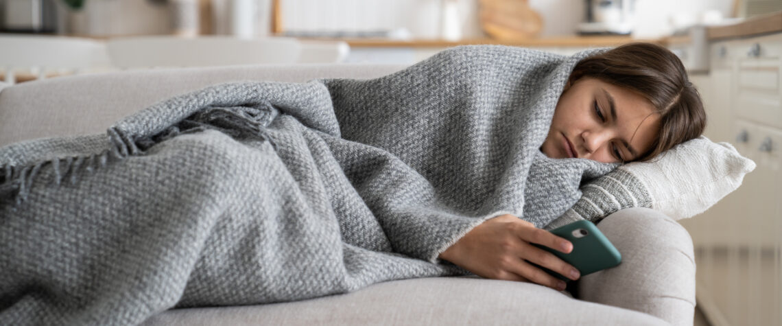 We Hold Big Tech Accountable - Teenage girl under a blanket on the couch | Nashville Christian Family Magazine - June 2023 issue - Free Christian Magazine