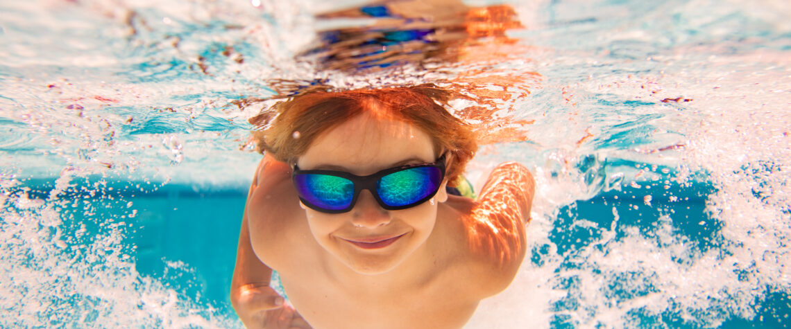 10 Ways to Beat the Summer Blues - Child with goggles swimming underwater | Nashville Christian Family Magazine July 2023 issue - free Christian magazine