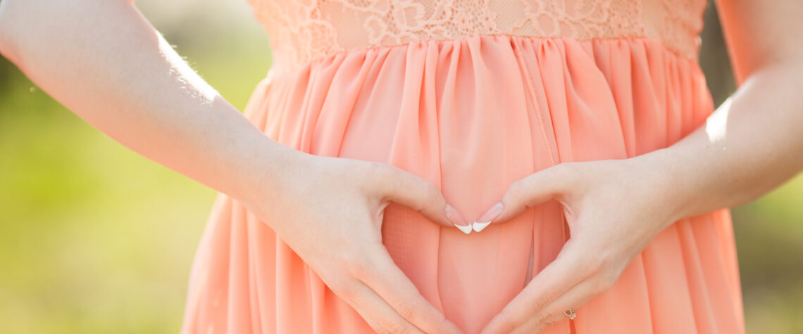 pregnant woman with heart hands | Nashville Christian Family Magazine