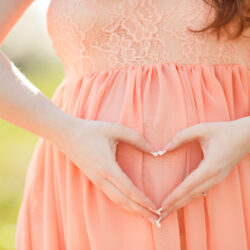 pregnant woman with heart hands | Nashville Christian Family Magazine