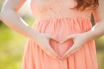 pregnant woman with heart hands | Nashville Christian Family Magazine