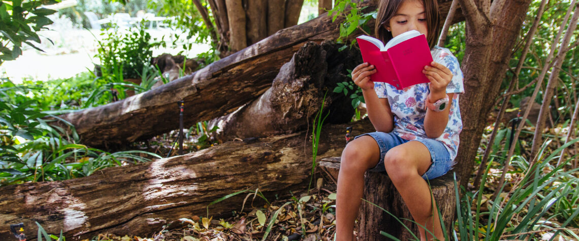 Little girl reading her Bible inthe woods | Nashville Christian Family Magazine