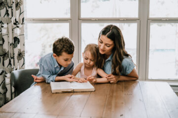 Parenting - mom with kids reading the bible | Nashville Christian Family Magazine - September 2024 issue