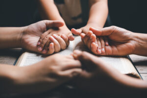 Dedicate Your Home to God - Family praying holding hands | Nashville Christian Family Magazine