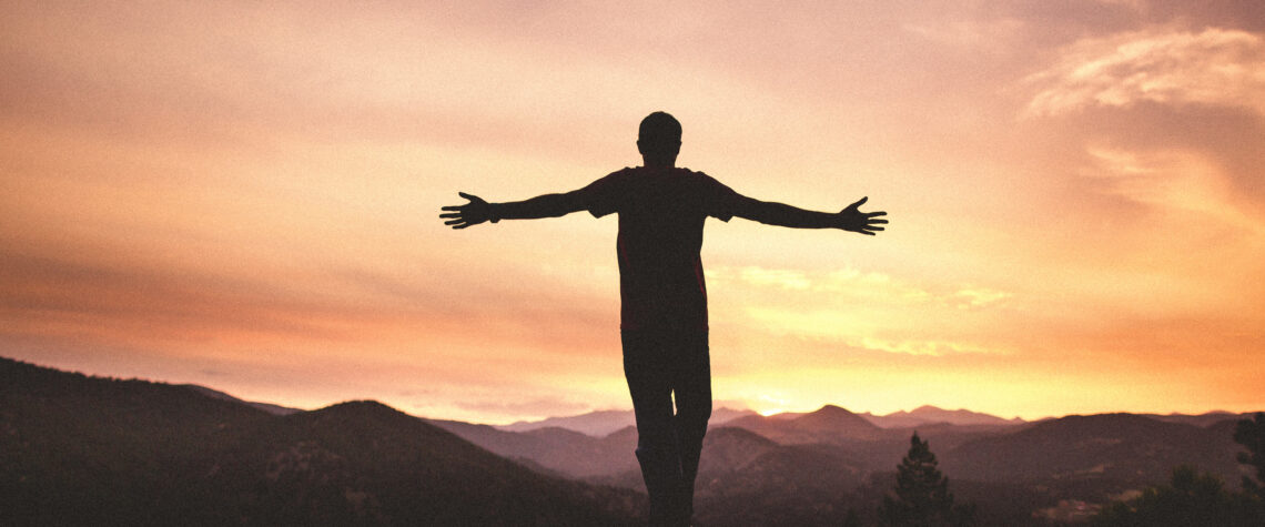 Mighty Men and Women - man with arms wide open at sunset | Nashville Christian Family Magazine