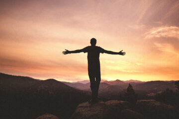 Mighty Men and Women - man with arms wide open at sunset | Nashville Christian Family Magazine